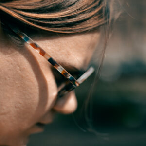 Fotografie, Portrait: Closeup einer Frau mit Sonnenbrille von der Seite.